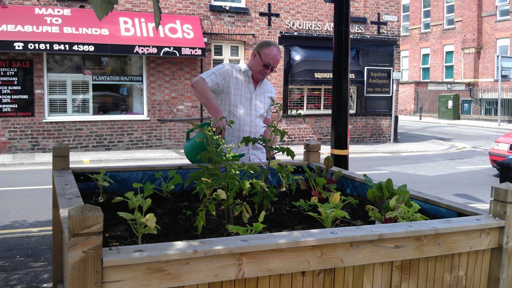 Mobility watering the planter for Art with a Heart